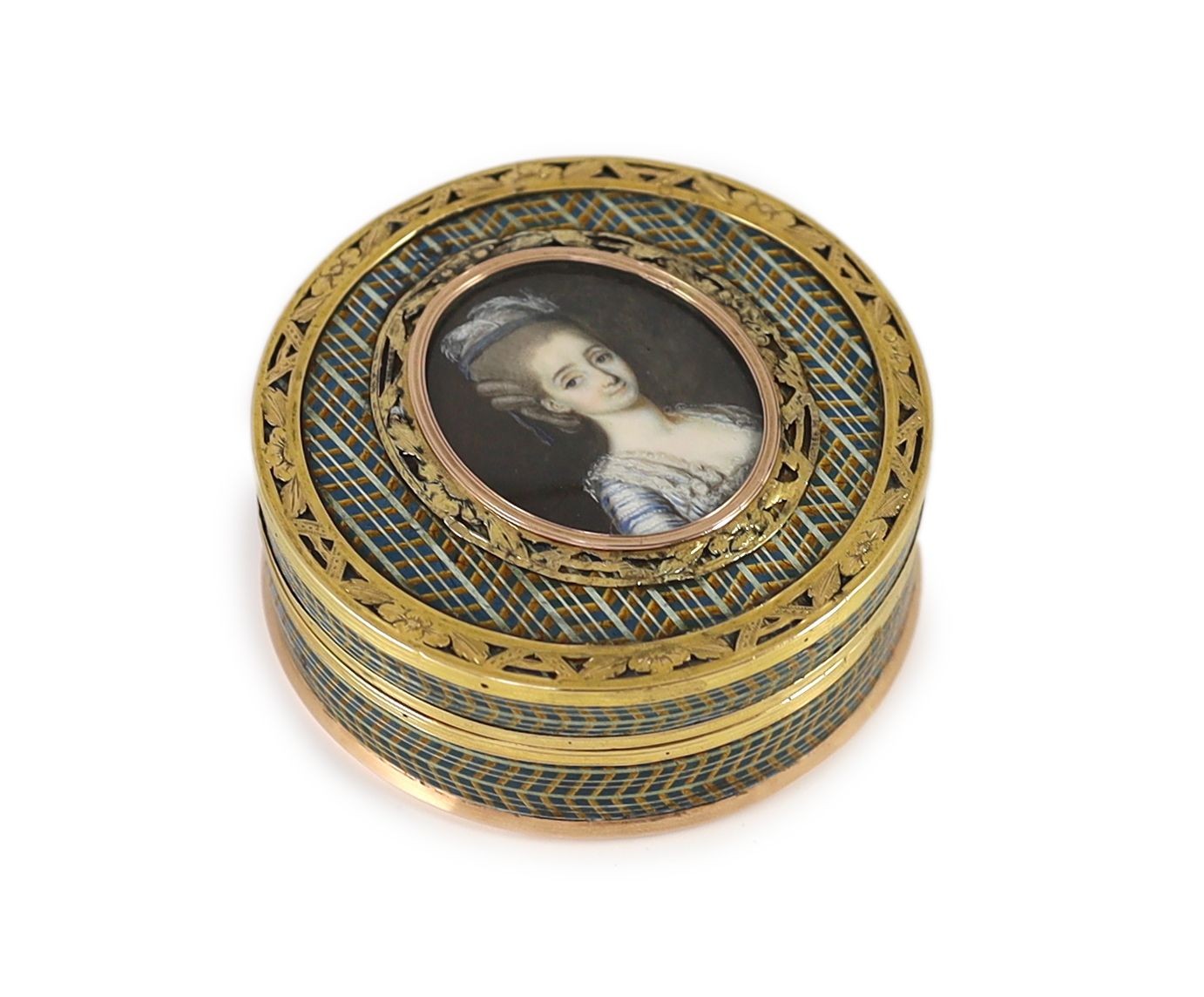 A late 18th century tortoiseshell boîte-à-miniature, the cove decorated with an inset portrait miniature of a young lady, mounted with pierced yellow metal borders 7.5cm diameter